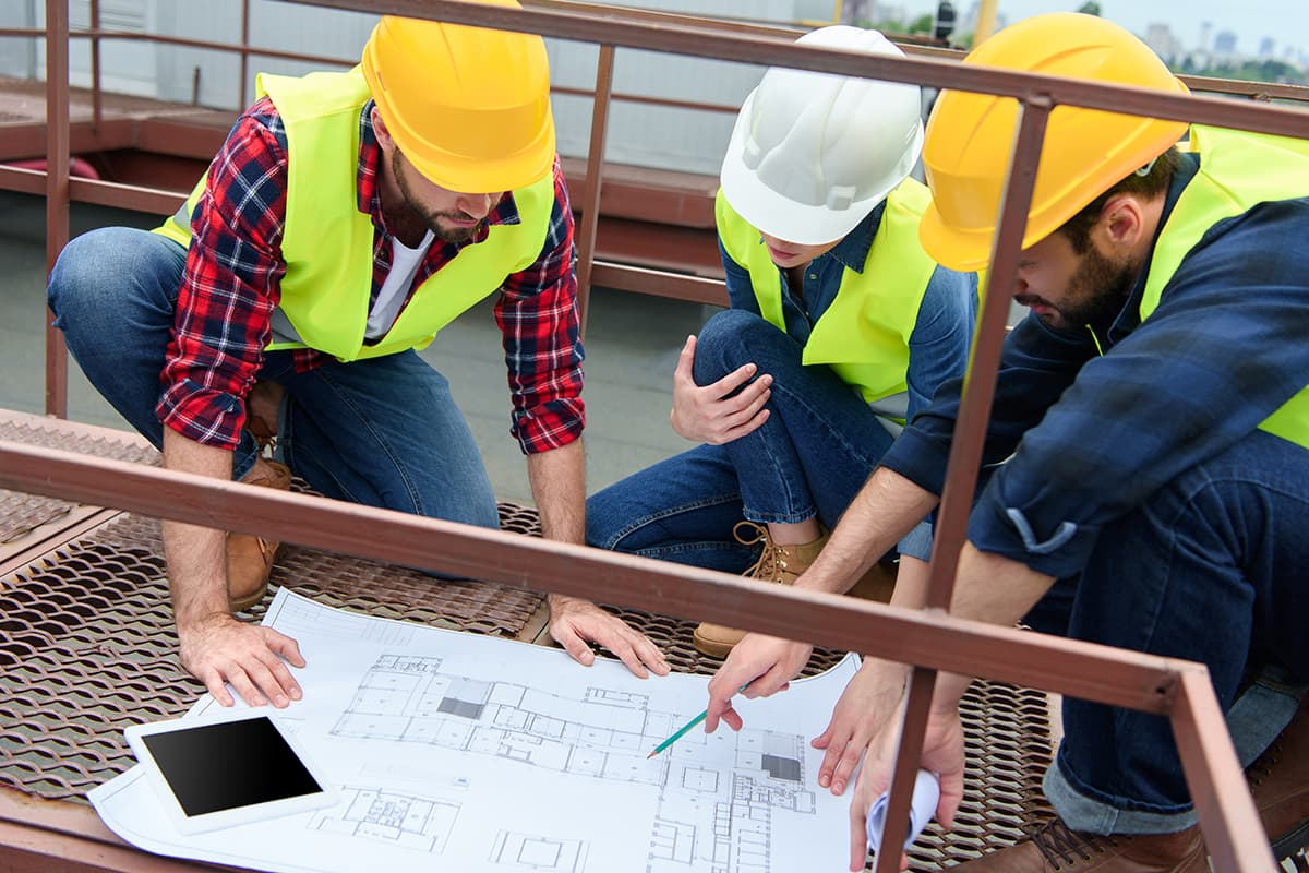 Equipo técnico de HC Consultores revisando planos en obra